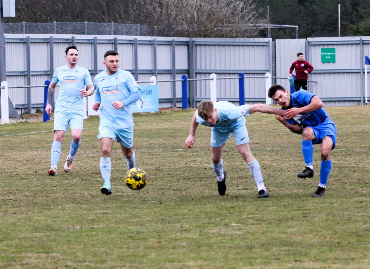 Ross Logan (right) takes a painful blow as he is held off in challenge for the ball on Saturday at Seafield Park.
