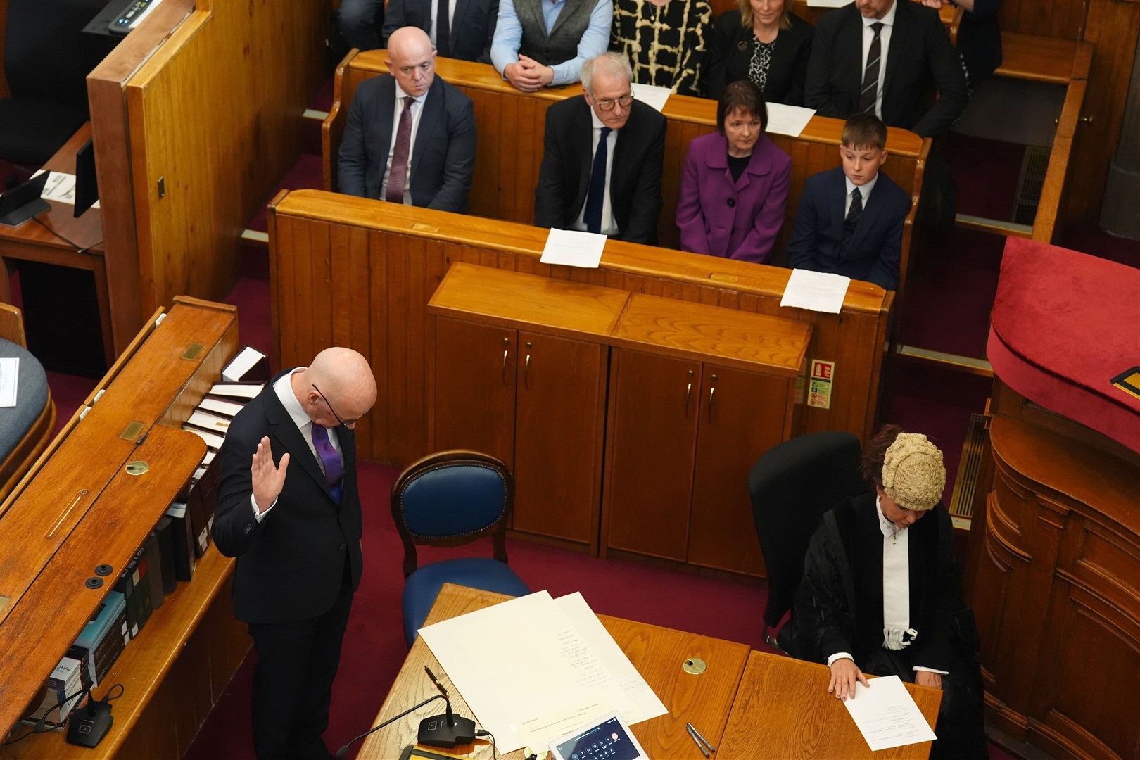 John Swinney, left, took the oath while his family watched on (Andrew Milligan/PA)