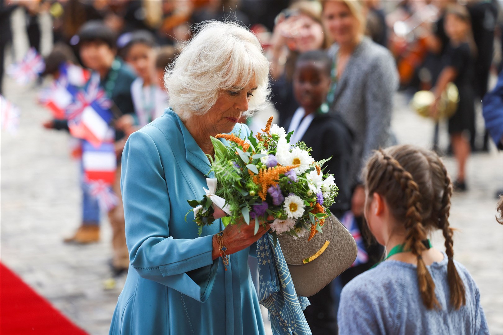 The Queen accepts a bouquet of flowers on her arrival in Bordeaux (Hannah McKay/PA)