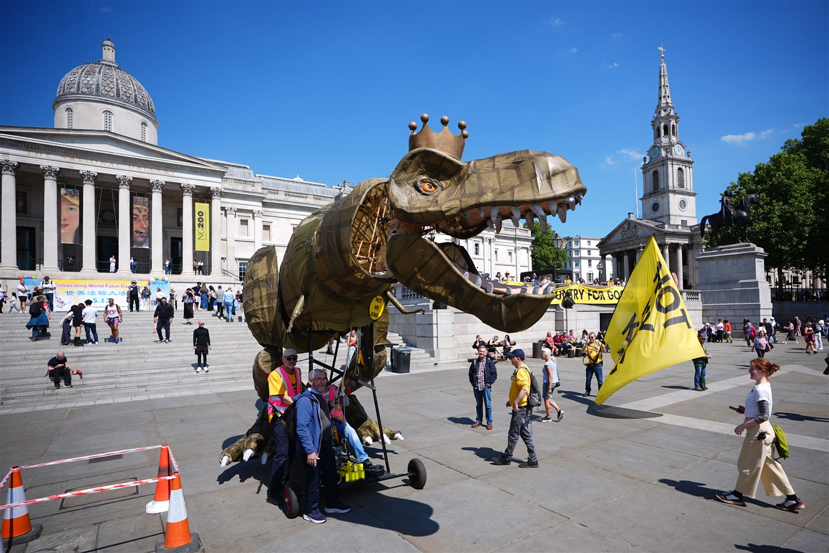 The protest in Trafalgar Square included a 15ft dinosaur mascot (James Manning/PA)