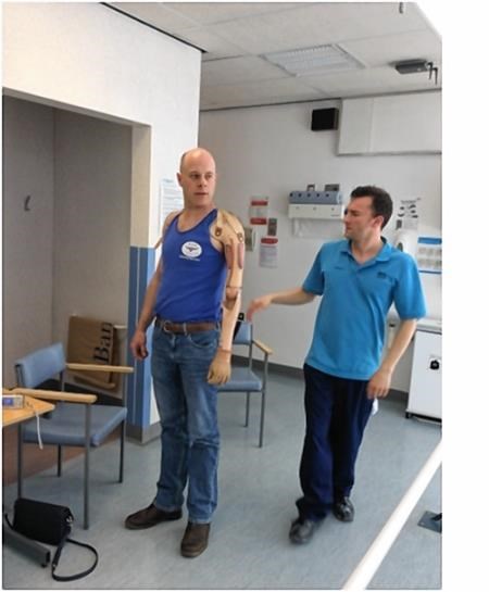 Donald Cameron (left) and prosthetist Vincent MacEachen put the new arm through its paces