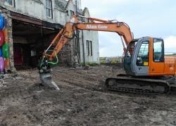 After years of standing derelict, the bulldozers move in to demolish part of the John O’Groats House Hotel. Its iconic façade and towers will remain as part of a complex of luxury holiday apartments. Photo: Willie Mackay.