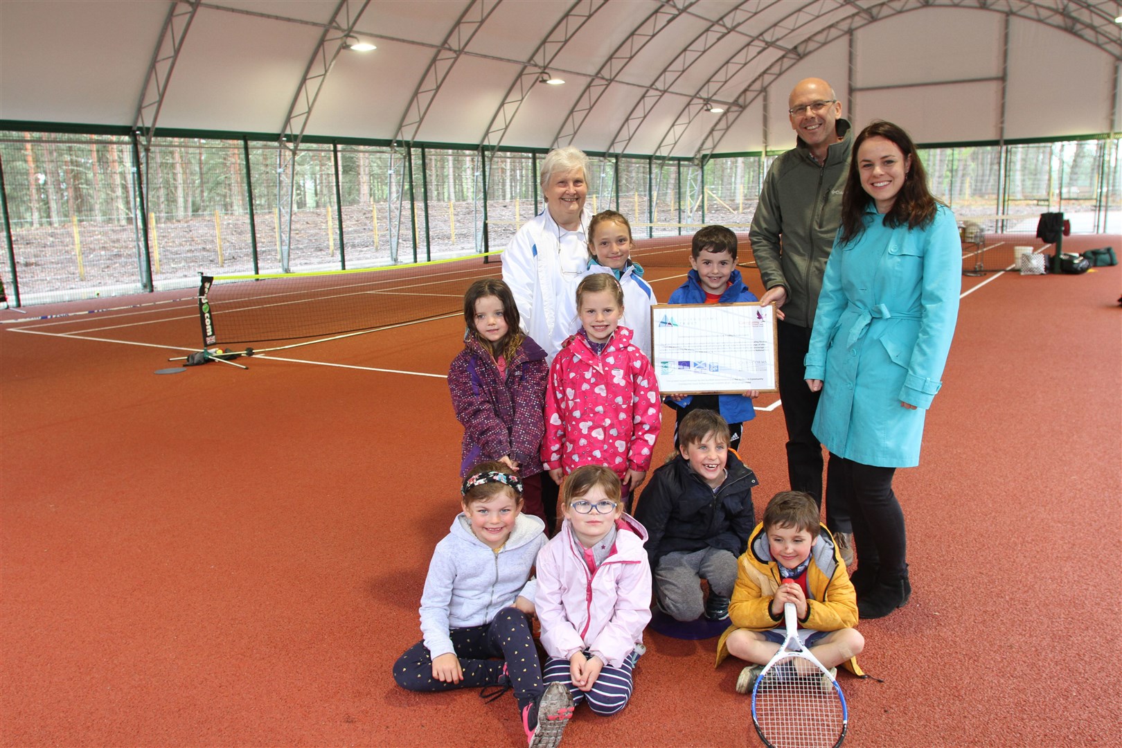 Davie Cameron, from Cairngorms Leader, Kate Forbes, Yvonne Birnie and some of the young tennis players who will benefit from the new court.