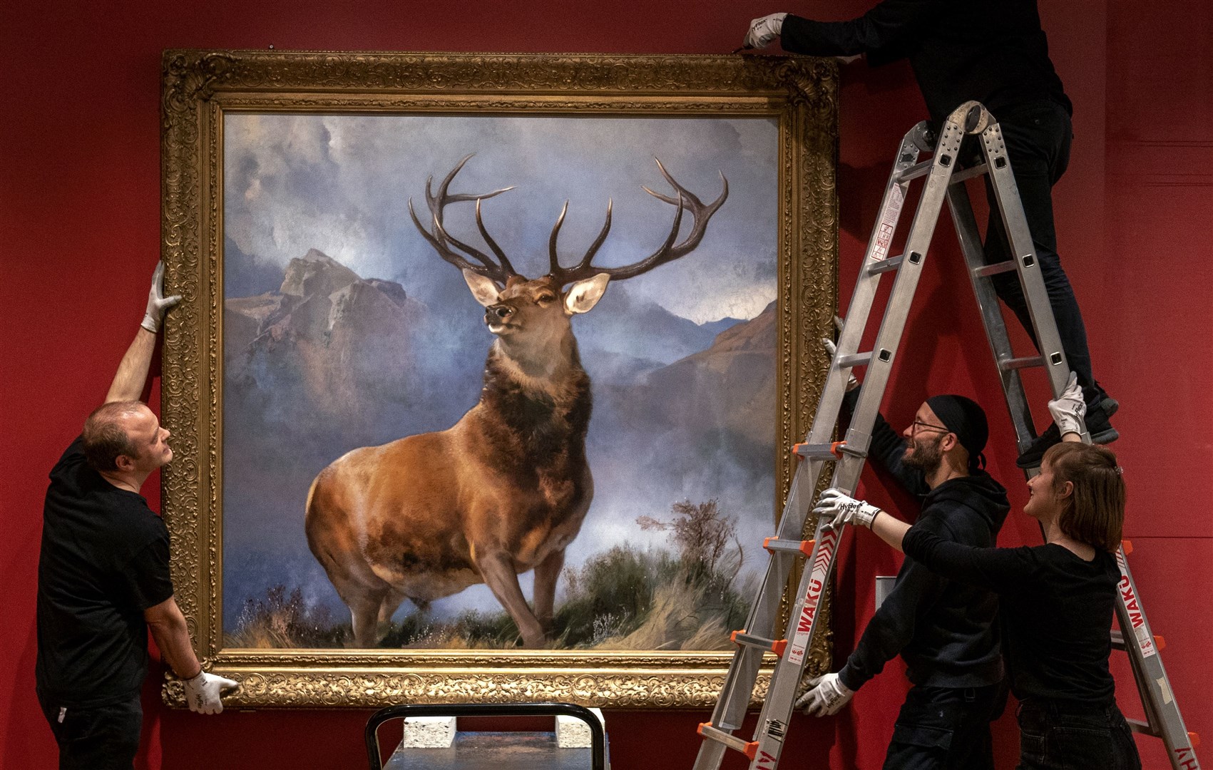 The painting was carefully moved into place (Jane Barlow/PA)