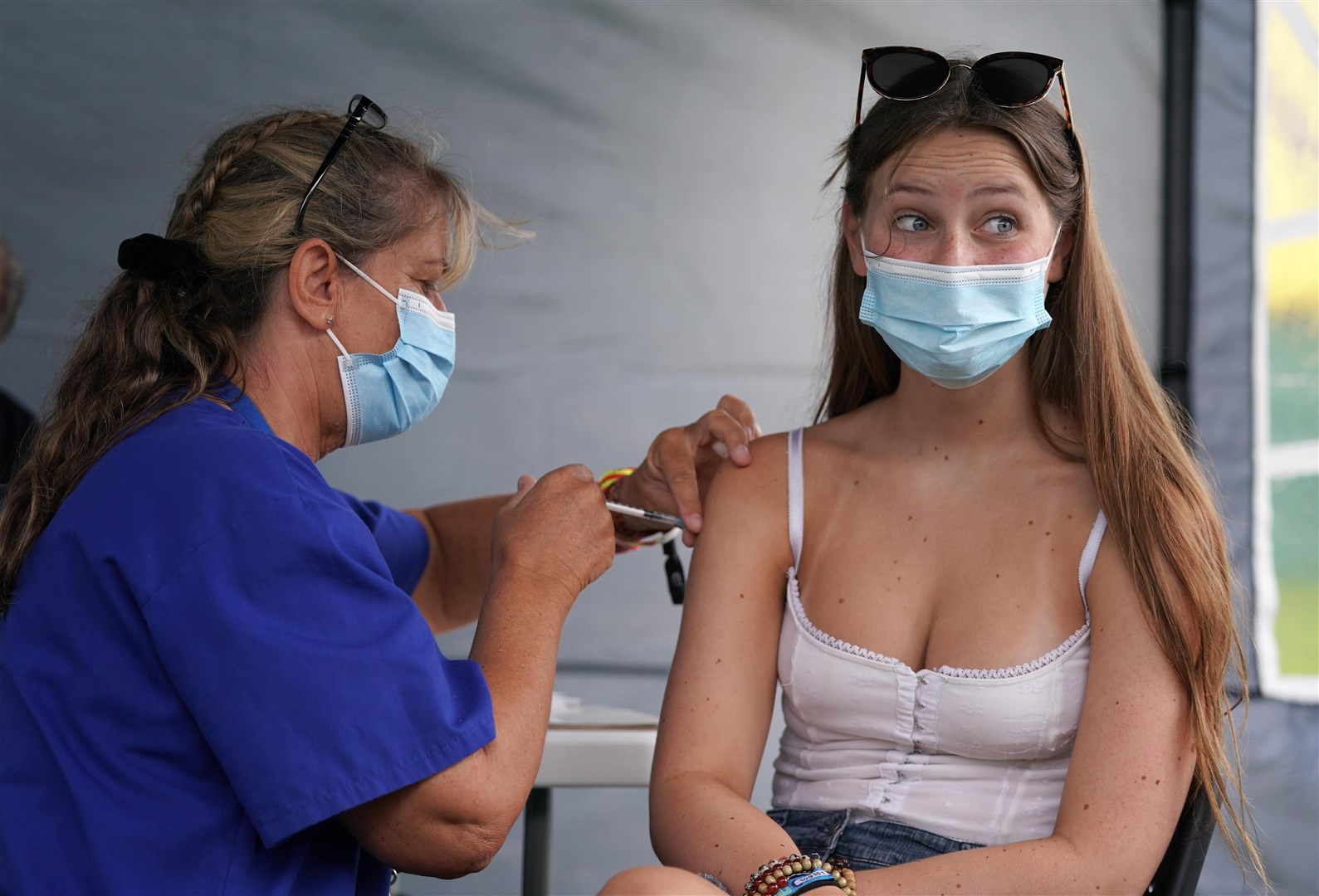Sixteen-year-old Lottie Beard getting a vaccine jab at a walk-in Covid-19 vaccination clinic at the Reading Festival (Kirsty O’Connor/PA)