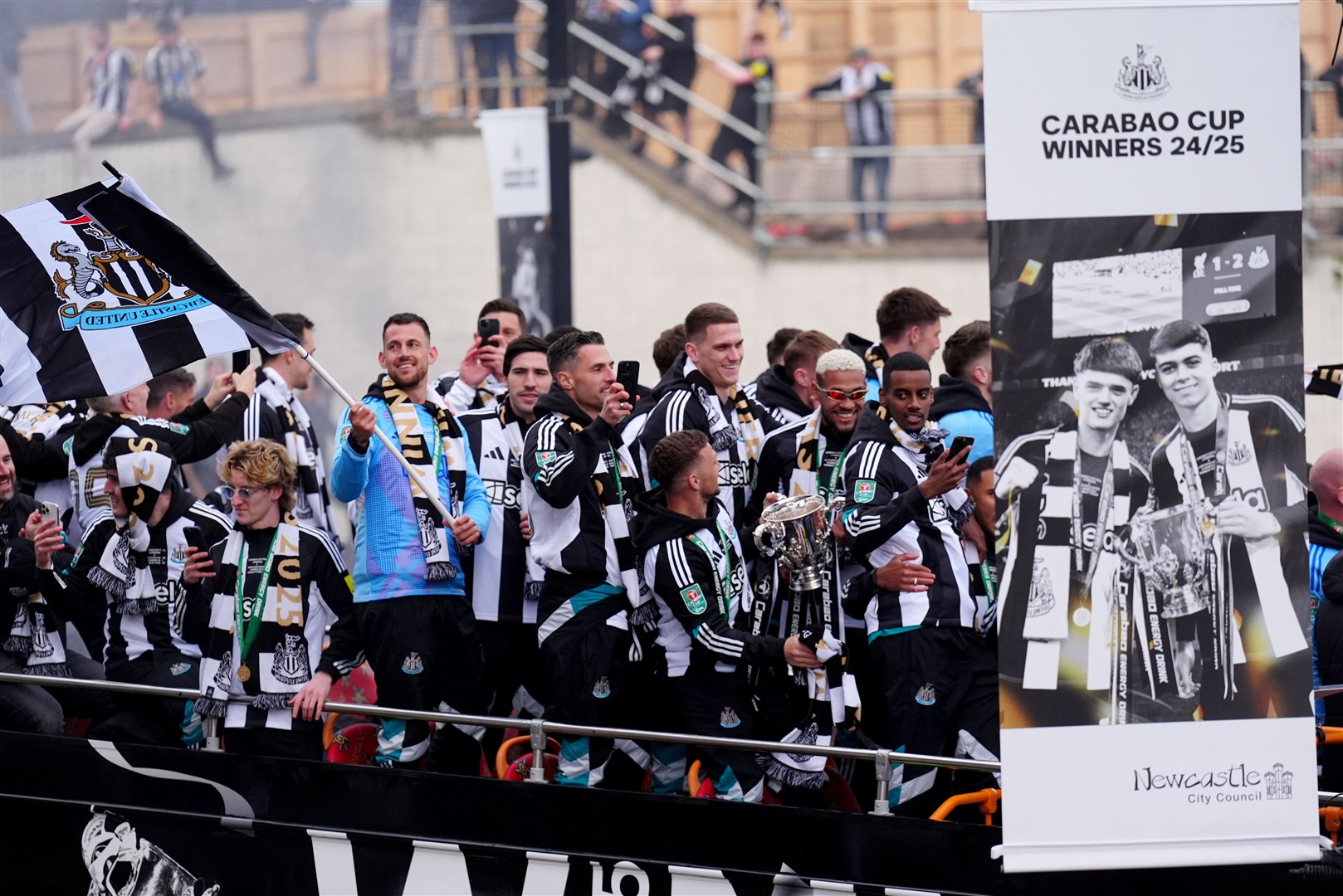 The open top buses carrying the Newcastle United players pass by St James’ Park (Owen Humphreys/PA)