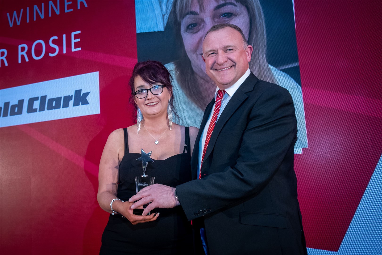 Clare Fraser accepted the award on her mother Heather Rosie's behalf, the prize presented by Inverness MP Drew Hendry. Picture: Callum Mackay