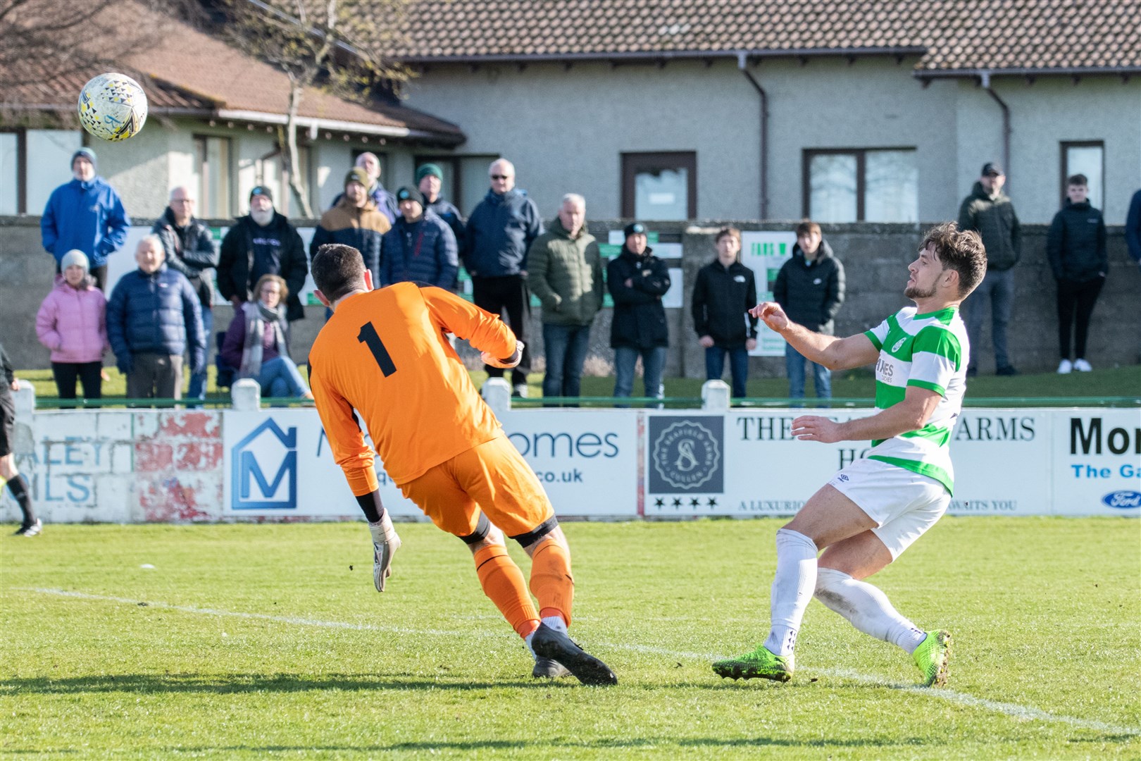 Buckie Thistle's Sam Urquhart lobs Strathspey keeper Robert Donaldson to score his hat-trick. Picture: Daniel Forsyth.