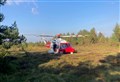 Mountain rescuers and helicopter aid injured mountain biker after crash