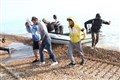 Migrants make off at speed as dinghy lands at Kent beach