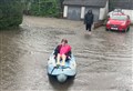Emily (9) makes the most of the monsoon rain in Aviemore