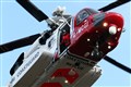 Man swept away during dog rescue airlifted to hospital