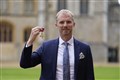 Former rugby referee Wayne Barnes jokes with William as he is made an OBE
