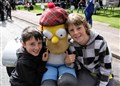 Charlie Gordon (left) and Sam Craig meet Homer Simpson who was on a Harley