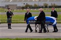 Alex Salmond’s body met by family and piper as plane lands in Aberdeen
