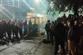 Angry students pull down security fences erected around halls of residence
