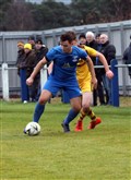 Strathspey Thistle's James McShane shields the ball.