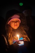 Girl with lit candle. Picture: Callum Mackay..