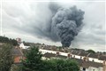 Huge plume of smoke rises above major fire at industrial site