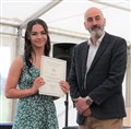 Poppy Riach shows off her prize-winner's certificate.