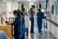 ‘Surge’ in norovirus cases in England adds to pressure on hospitals