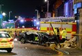 At least one casualty after car crashes into Inverness building 