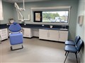 The dentist chair and wider room in the out-patients department.