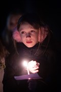Girl with lit candle. Picture: Callum Mackay..