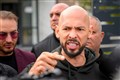 Andrew Tate checks in at police station on return to Romania