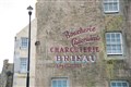 'Boucherie Charcuterie Charcuterie Brieau Specialites' was painted on the side of this harbour facing building. The area around the harbour in Portsoy underwent a transformation ahead of the filming of Peaky Blinders. Picture: Daniel Forsyth