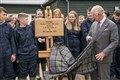 King meets pupils learning rural skills after helping to save estate