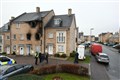 Two children killed and mother suffers life-changing injuries in house fire