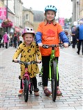 Maggie and Mollie Roden cycle to see dad Paul's return. Picture Gary Anthony