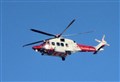 Rescue helicopter searching River Spey in Aviemore