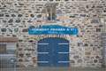 A French sign 'Clement Freres & Cie - Whisky' was placed on this harbour facing building with wooden shed added to the exterior also. Picture: Daniel Forsyth