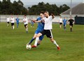 Alan Hardwick (left) gets a toe to the ball for the Jags.