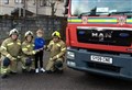 Grantown brigade pass on 'Santa' cheque to Nethy gardeners