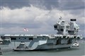 Aircraft carrier postpones sailing after crew members test positive for virus