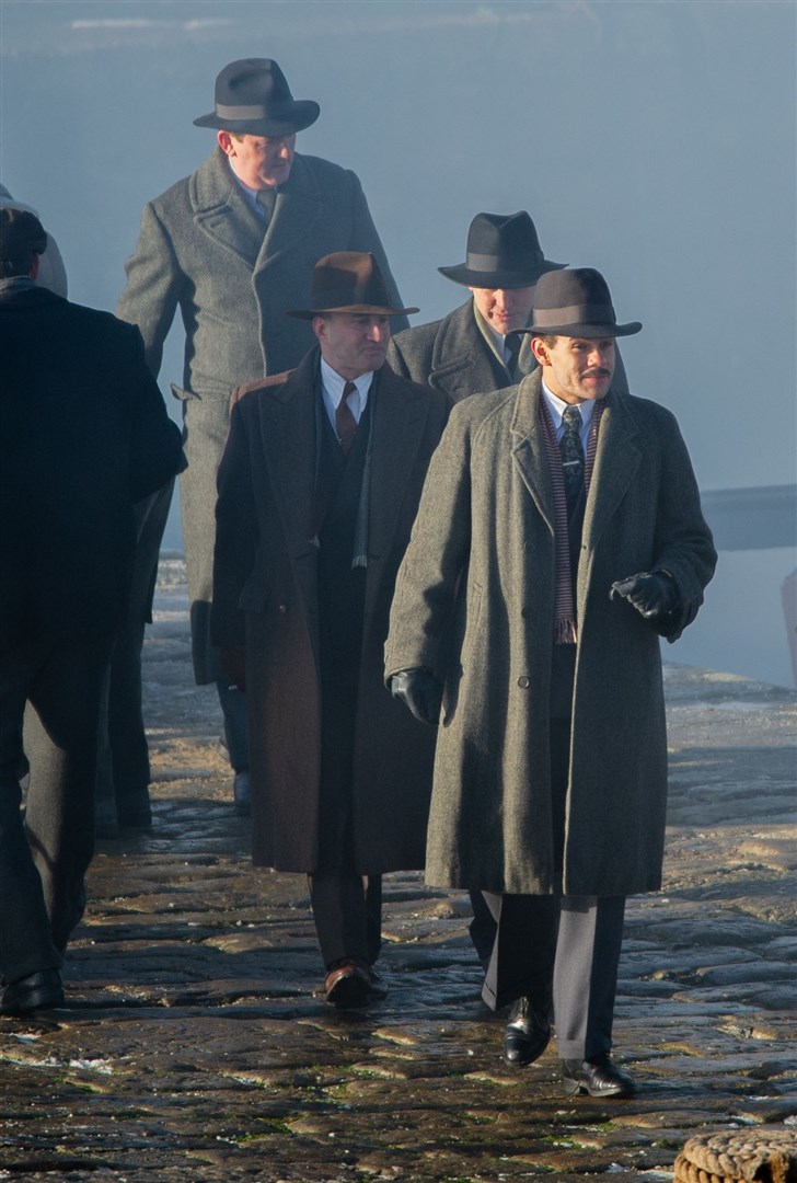 Gangsters - associated with Michael Gray - walk the harbour pier.Picture: Daniel Forsyth