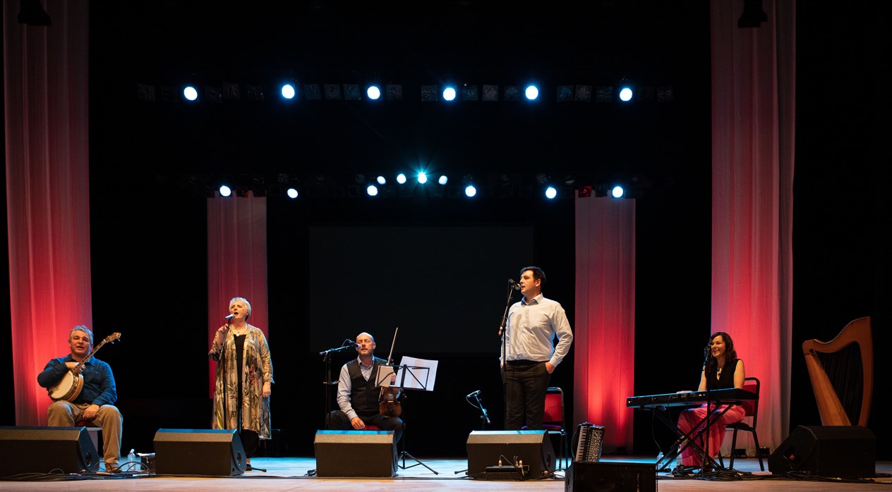 Glenfinnan Ceilidh Band perform on stage awith special guest Gaelic singer, Margaret Stewart Eden Court Theatre on the openng night of live music, The Royal National Mòd 2021