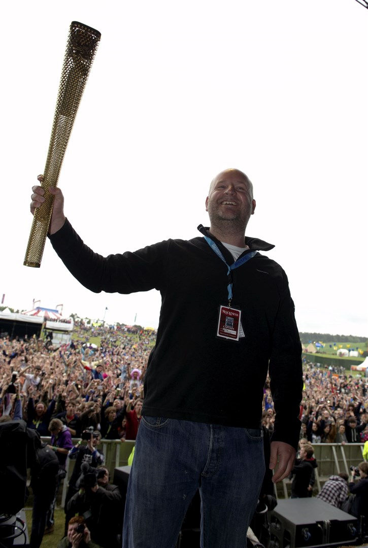 Rockness 2012 on Saturday afternoon the Olympic torch dropped in, held here by one of the festival promoters Jim King. Picture: Callum Mackay
