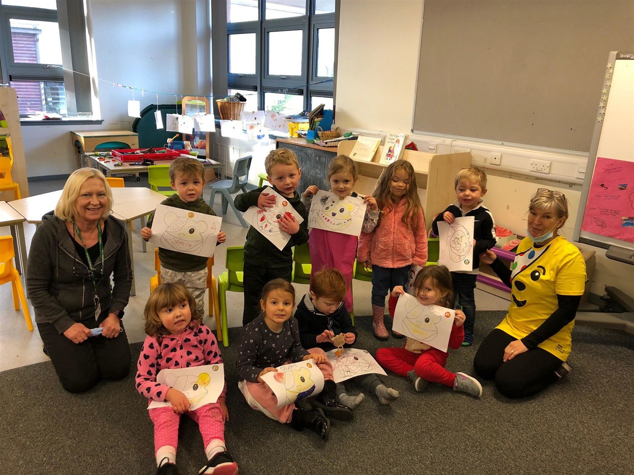 The youngest pupils show off their Pudsey artwork.