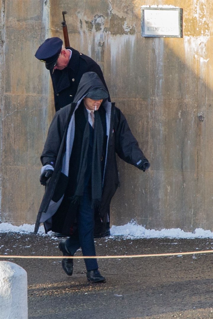 Wearing a jacket to keep warm Cillian Murphy, as Thomas Shelby, smokes during a gap in filming. ..Picture: Daniel Forsyth..