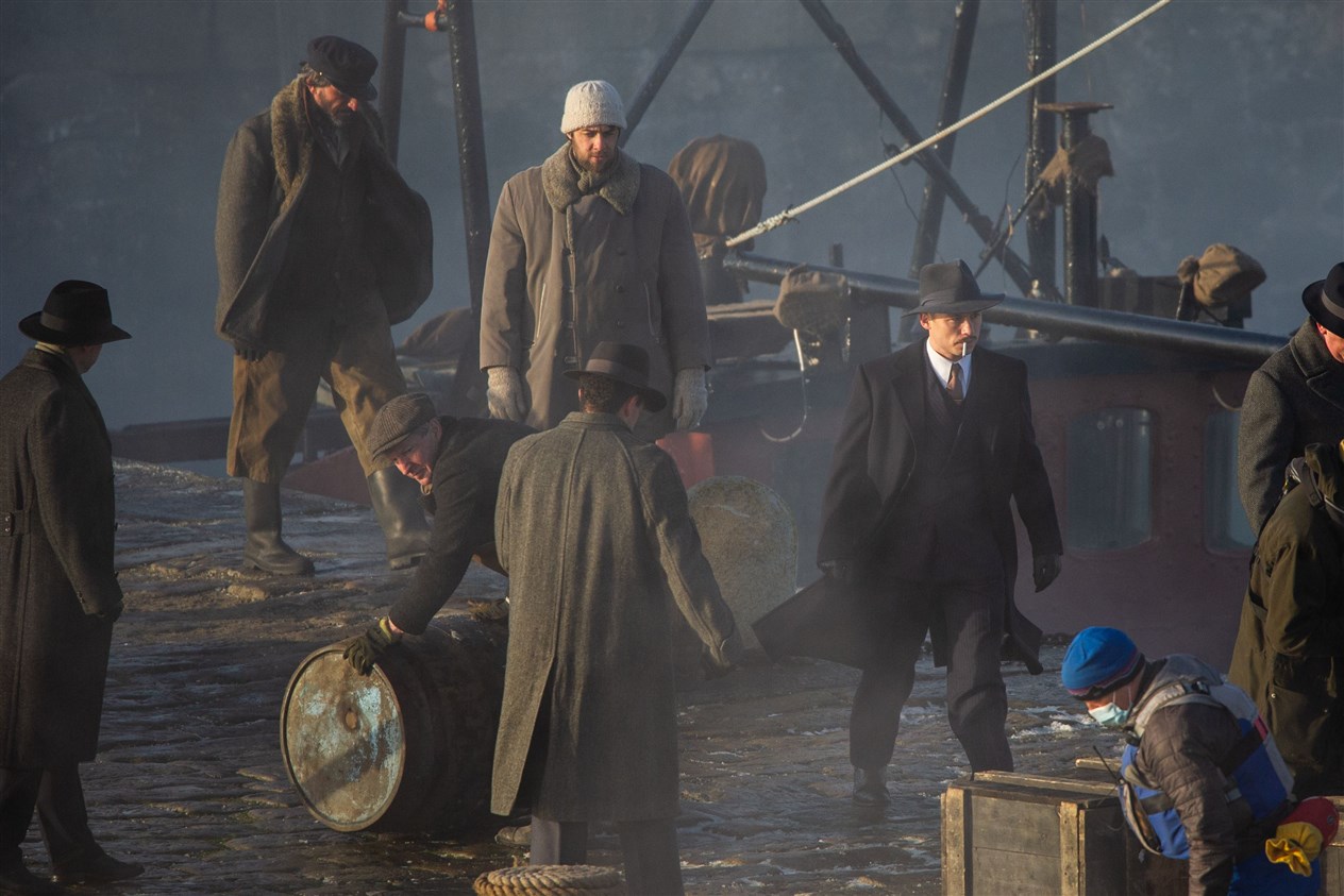 Michael Gray (pictured centre right), played by Finn Cole, is involved with the final days filming at Portsoy as the cast and crew film on the new harbour. ..Picture: Daniel Forsyth..