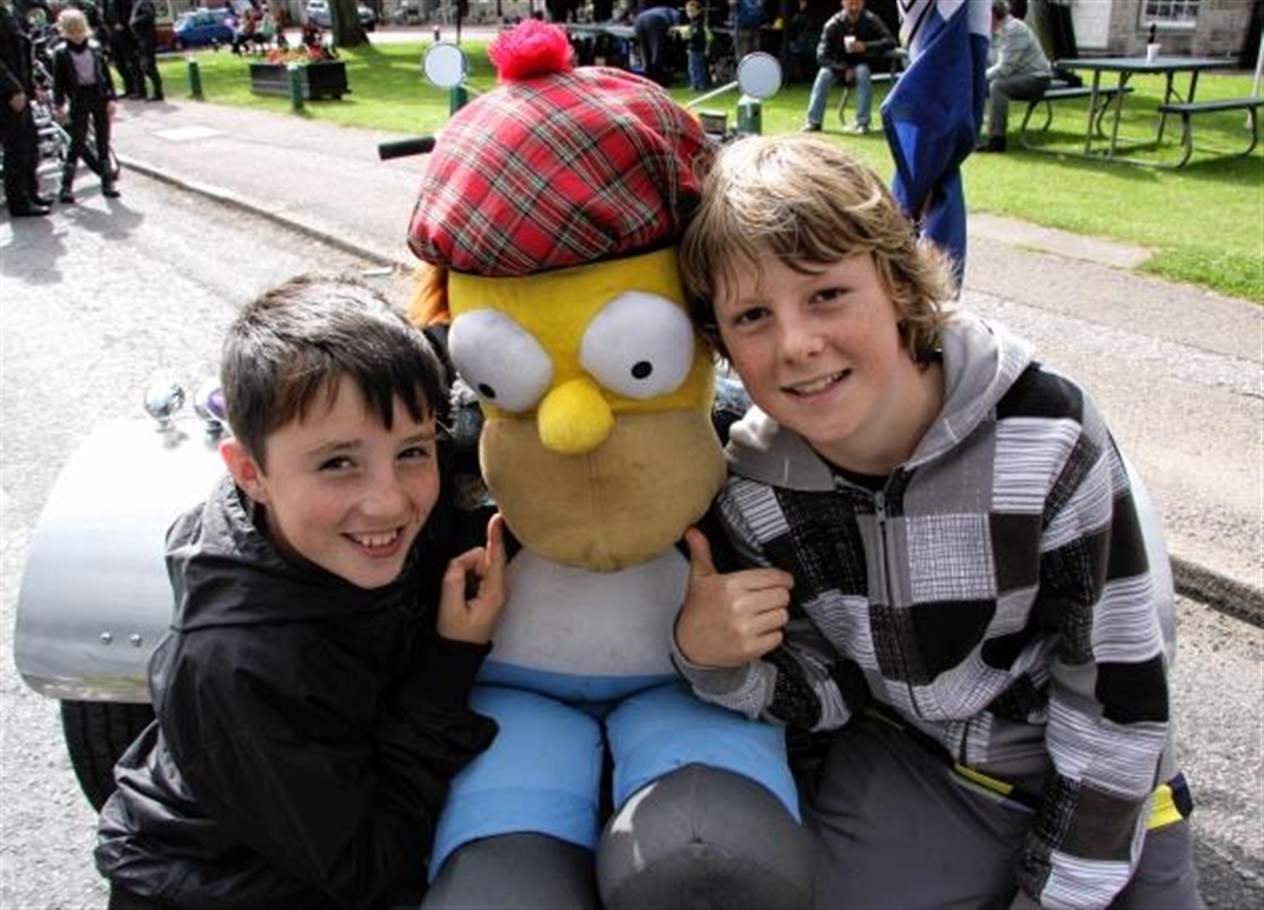 Charlie Gordon (left) and Sam Craig meet Homer Simpson who was on a Harley