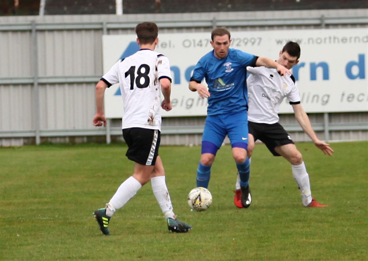 The home team's Craig Macmillan at the centre of the action.