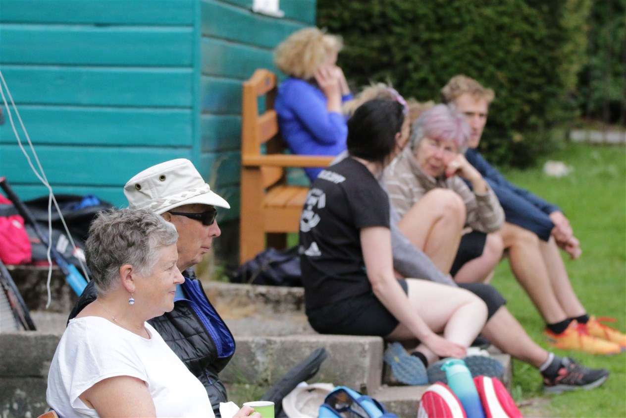 Spectators taking in the play on a lovely day for tennis.