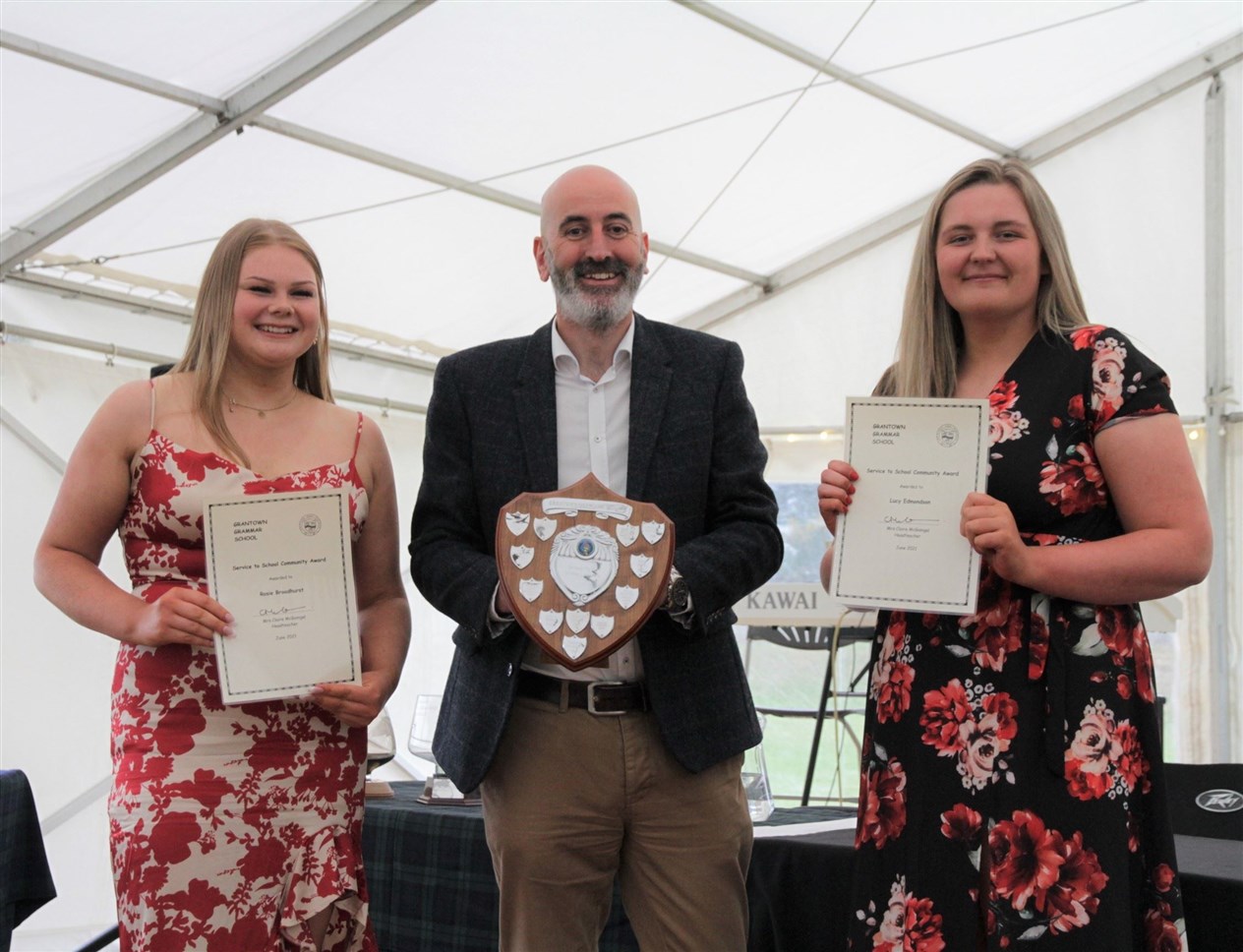 Rose Broadhurst and Lucy Edmondson receive their Service to School Community Award from Ewen Mackintosh.