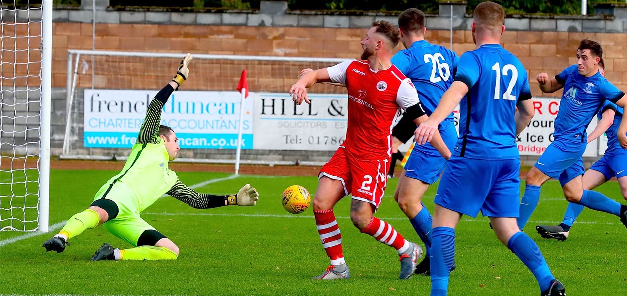 Strathspey Thistle stopper Michael MacCallum is at full stretch as teammates Richard Tawse and Martin Duncan look on. Pic: John Mcintyre