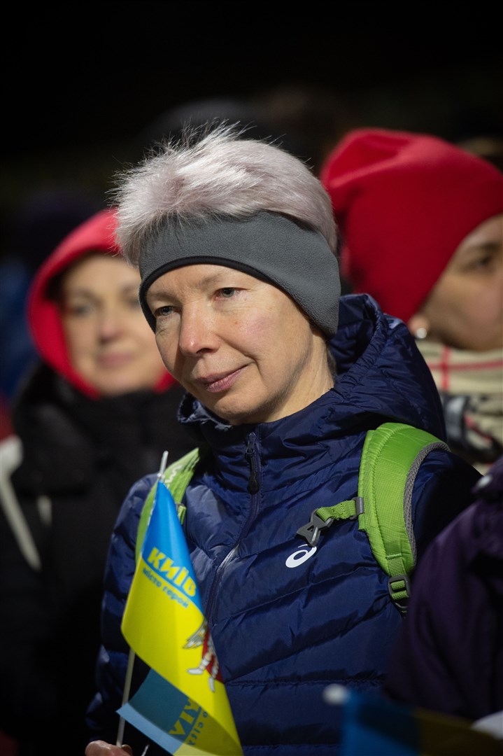 Woman holding flag. Picture: Callum Mackay..